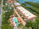 Overhead view of community pool, tennis courts, and buildings at Hidden Lagoon at 1695 Pinellas Bayway S # E4, Tierra Verde, FL 33715
