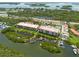 Aerial view showcasing waterfront property with boat docks and lush landscaping at 1695 Pinellas Bayway S # E4, Tierra Verde, FL 33715