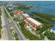 Aerial view of waterfront community with pool and tennis court at 1695 Pinellas Bayway S # E4, Tierra Verde, FL 33715