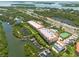 Aerial view of waterfront community with boat docks and tennis court at 1695 Pinellas Bayway S # E4, Tierra Verde, FL 33715