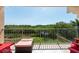 Relaxing balcony with red chairs and a view of lush greenery at 1695 Pinellas Bayway S # E4, Tierra Verde, FL 33715