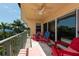 Balcony with red chairs and partial water view at 1695 Pinellas Bayway S # E4, Tierra Verde, FL 33715