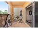 Relaxing balcony with outdoor furniture and sliding door access at 1695 Pinellas Bayway S # E4, Tierra Verde, FL 33715