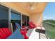 Balcony with red chairs and a view of the water at 1695 Pinellas Bayway S # E4, Tierra Verde, FL 33715