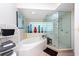 Spa-like bathroom with soaking tub, walk-in shower, and tile flooring at 1695 Pinellas Bayway S # E4, Tierra Verde, FL 33715