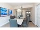 Elegant dining room features a modern table, gray chairs, and kitchen view at 1695 Pinellas Bayway S # E4, Tierra Verde, FL 33715