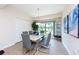 Bright dining room with modern table and chairs, hardwood floor, and large windows at 1695 Pinellas Bayway S # E4, Tierra Verde, FL 33715