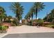 Gated entrance to Hidden Lagoon community with palm trees and brick driveway at 1695 Pinellas Bayway S # E4, Tierra Verde, FL 33715