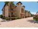 Mediterranean-style building with balconies and lush landscaping at 1695 Pinellas Bayway S # E4, Tierra Verde, FL 33715