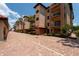 Mediterranean-style building with balconies, landscaping, and brick driveway at 1695 Pinellas Bayway S # E4, Tierra Verde, FL 33715