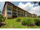 Building exterior showcasing multiple balconies and lush landscaping at 1695 Pinellas Bayway S # E4, Tierra Verde, FL 33715