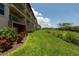 Building exterior with manicured lawn and landscaping at 1695 Pinellas Bayway S # E4, Tierra Verde, FL 33715