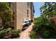 Exterior kayak storage near a walkway with lush landscaping at 1695 Pinellas Bayway S # E4, Tierra Verde, FL 33715
