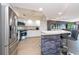 Kitchen with breakfast bar, stainless steel appliances, and stone accent wall at 1695 Pinellas Bayway S # E4, Tierra Verde, FL 33715