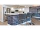 Kitchen breakfast bar with seating and stone accent wall at 1695 Pinellas Bayway S # E4, Tierra Verde, FL 33715