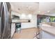 Bright kitchen featuring stainless steel appliances and white cabinetry at 1695 Pinellas Bayway S # E4, Tierra Verde, FL 33715