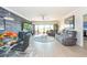Bright living room with hardwood floors, comfy seating, and a large TV at 1695 Pinellas Bayway S # E4, Tierra Verde, FL 33715