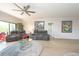 Relaxing living room with gray couches and a ceiling fan at 1695 Pinellas Bayway S # E4, Tierra Verde, FL 33715