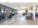 Spacious living room with hardwood floors, large TV, and comfortable seating at 1695 Pinellas Bayway S # E4, Tierra Verde, FL 33715