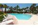 Relaxing community pool with lounge chairs at 1695 Pinellas Bayway S # E4, Tierra Verde, FL 33715