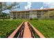 Walkway leading to building and lush landscaping at 1695 Pinellas Bayway S # E4, Tierra Verde, FL 33715