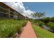 Walkway leading to waterfront with lush landscaping at 1695 Pinellas Bayway S # E4, Tierra Verde, FL 33715