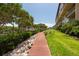 Landscaped walkway beside building and water at 1695 Pinellas Bayway S # E4, Tierra Verde, FL 33715