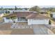 Single-story home with brown roof, white exterior, and landscaped yard at 1732 Flamingo Ln, Sun City Center, FL 33573