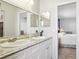 Updated bathroom with double vanity and view into bedroom at 1732 Flamingo Ln, Sun City Center, FL 33573
