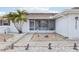 House exterior featuring walkway, landscaping, and screened entry at 1732 Flamingo Ln, Sun City Center, FL 33573