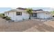 White single story home with a gravel yard at 1732 Flamingo Ln, Sun City Center, FL 33573