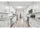 Updated kitchen featuring white cabinets and granite countertops at 1732 Flamingo Ln, Sun City Center, FL 33573