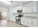 Bright kitchen with white cabinets, granite countertops, and stainless steel appliances at 1732 Flamingo Ln, Sun City Center, FL 33573