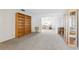 Bright living room featuring neutral carpeting and built-in shelving at 1732 Flamingo Ln, Sun City Center, FL 33573