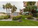 The Beach Cottage entrance, with palm trees and well-manicured lawn at 18400 Gulf Blvd # 1505, Indian Shores, FL 33785