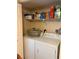 Functional laundry room with washer, dryer, and shelving at 18400 Gulf Blvd # 1505, Indian Shores, FL 33785