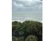 Breathtaking ocean view from the balcony, showing the beach and the cloudy sky at 18400 Gulf Blvd # 1505, Indian Shores, FL 33785