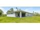 Gray house with covered patio and grassy backyard at 191 Prineville St, Port Charlotte, FL 33954