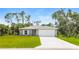 Gray house with white garage door and green lawn at 191 Prineville St, Port Charlotte, FL 33954