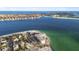 Stunning aerial view of beachfront condos in a coastal community with beautiful blue ocean at 200 1St Ave # 312, St Pete Beach, FL 33706