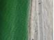 Stunning aerial view of the beach and the clear turquoise ocean at 200 1St Ave # 312, St Pete Beach, FL 33706