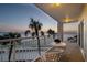 Cozy balcony with comfortable seating offers amazing ocean views and tropical palm trees at 200 1St Ave # 312, St Pete Beach, FL 33706