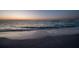 Sunset view of the beach featuring calm water and pristine sand at 200 1St Ave # 312, St Pete Beach, FL 33706