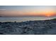 Picturesque rocky beach view with a beautiful sunset over the ocean horizon at 200 1St Ave # 312, St Pete Beach, FL 33706
