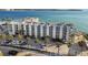 A beautiful condo building near the beach with palm trees, ample parking, and stunning ocean views at 200 1St Ave # 312, St Pete Beach, FL 33706