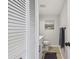 Stylish half-bath with white vanity, modern fixtures, and neutral decor at 200 1St Ave # 312, St Pete Beach, FL 33706