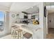 Bright kitchen featuring white cabinets, stainless appliances, a breakfast bar, and views of the ocean at 200 1St Ave # 312, St Pete Beach, FL 33706
