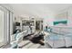 Bright living room with modern decor open to kitchen and dining area at 200 1St Ave # 312, St Pete Beach, FL 33706