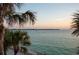 Breathtaking ocean view with sailboat and tropical palms at sunset at 200 1St Ave # 312, St Pete Beach, FL 33706