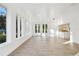 Sunlit living room featuring hardwood floors and wall-to-wall windows at 201 S Shore Crest Dr, Tampa, FL 33609